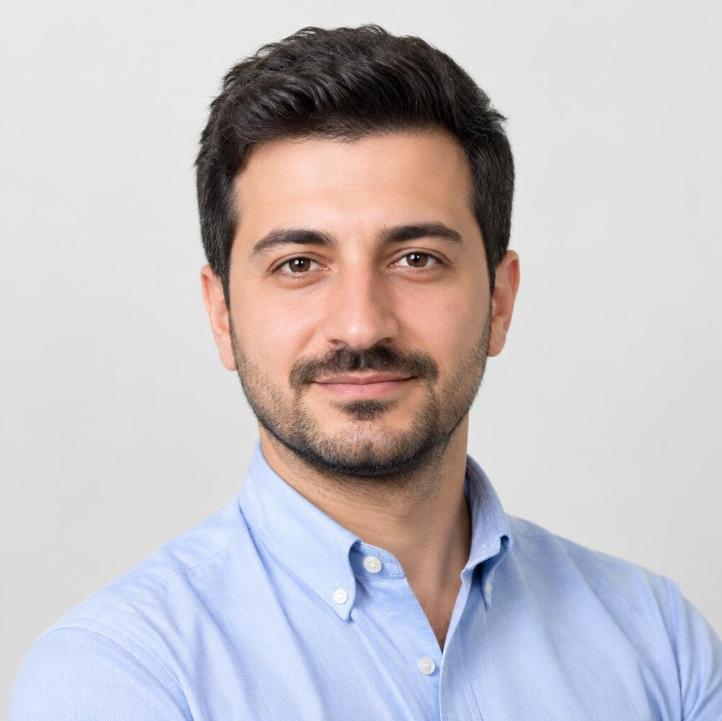 Portrait of a bearded man in a casual shirt looking at the camera